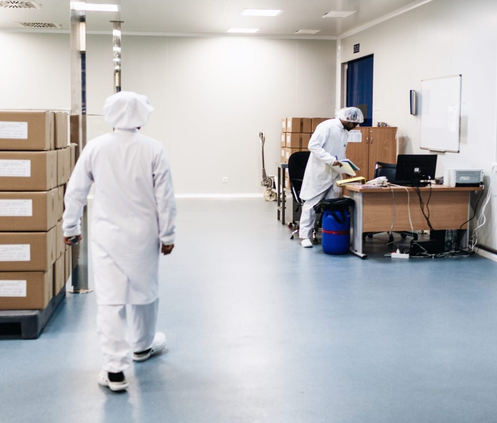 two-men-working-in-a-warehouse-wearing-white-apron-2023-11-27-05-17-18-utc